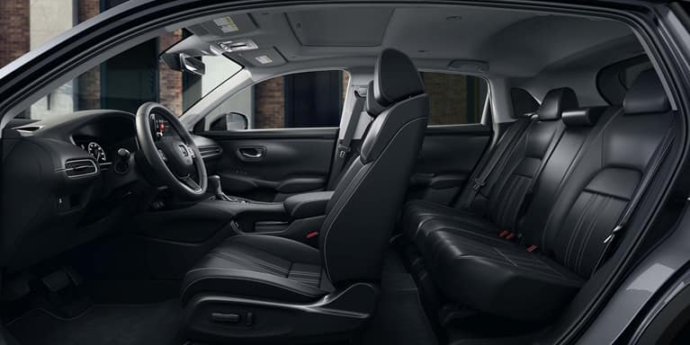 2027 Honda HR-V EX-L side view of the front and rear black leather seats and dashboard (Subcompact Crossover SUV).